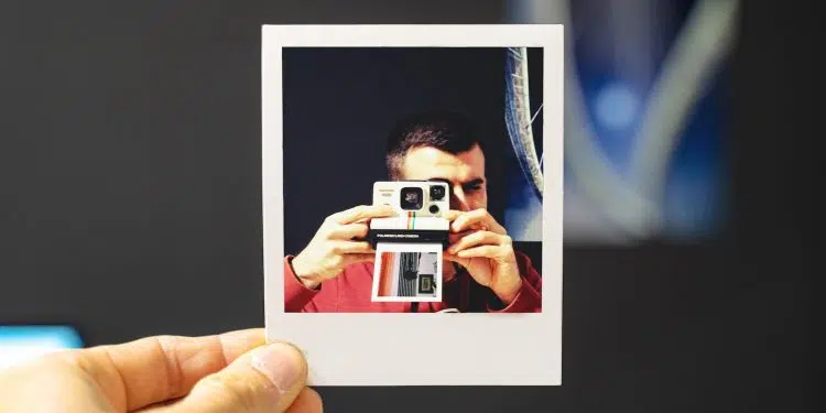 person holding white and red camera